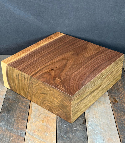 Wooden block on a rustic wooden surface with a dark background
