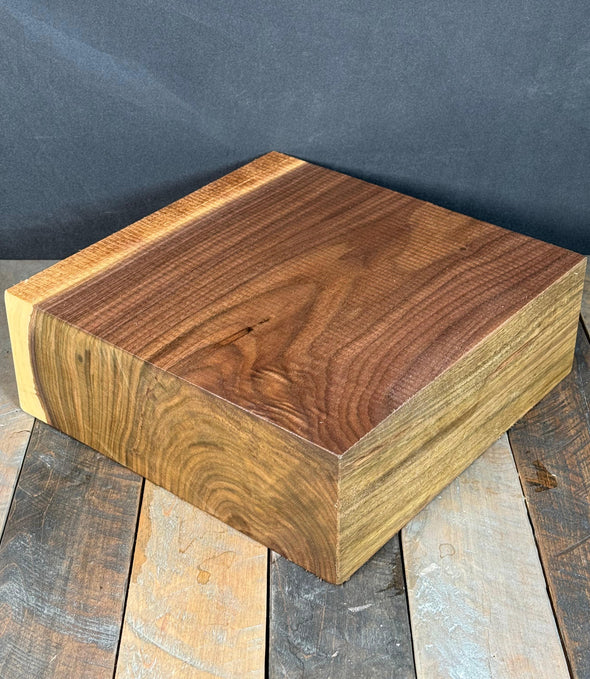 Wooden block on a rustic wooden surface with a dark background