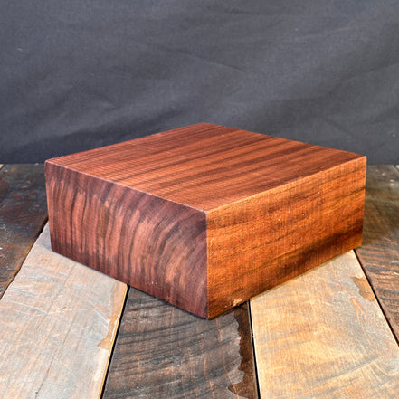 Wooden blocks with different finishes on a dark fabric background