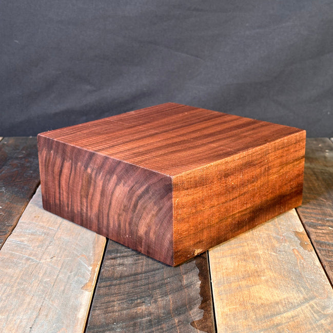 Wooden blocks with different finishes on a dark fabric background
