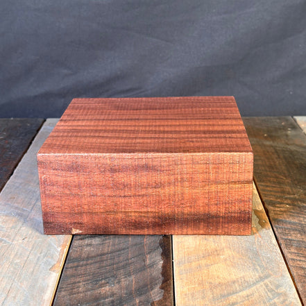 Wooden block on a dark gray background